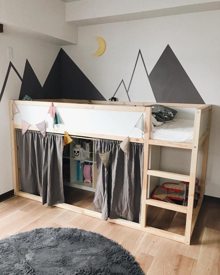 Charcoal-curtained wooden bedroom nook from @_rie_mumof2. ikea kura bed ideas for boys with mountain mural and storage.