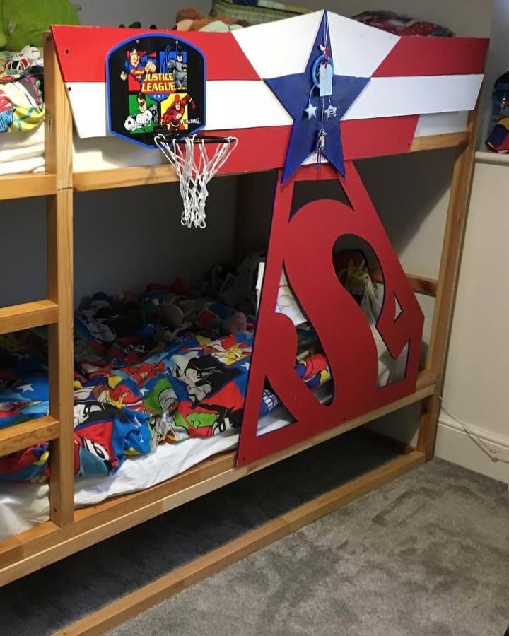 Red, white, and blue superhero KURA bunk bed from @welsh1930srenovation. Shared childrenโs room with basketball hoop and comic bedding.