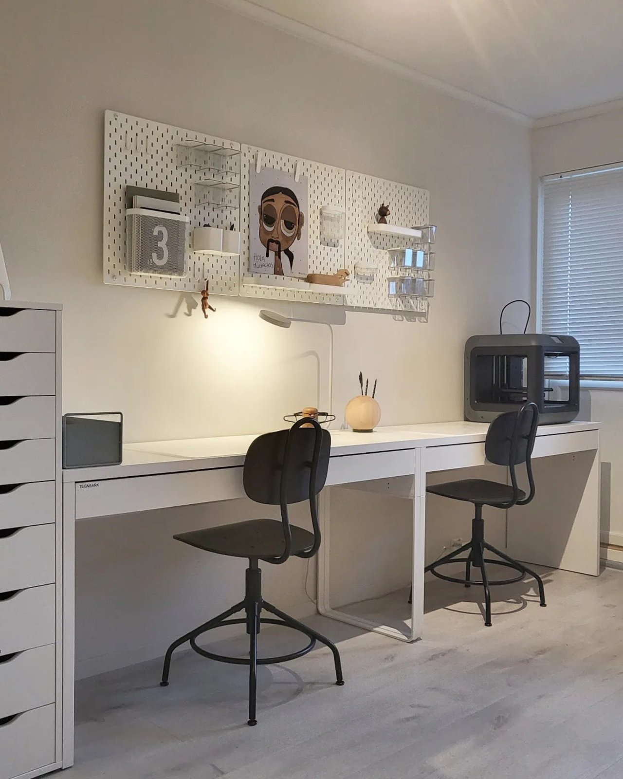 ikea skadis craft room ideas with white pegboards, clear bins, shelves, hooks, and a spacious work desk
