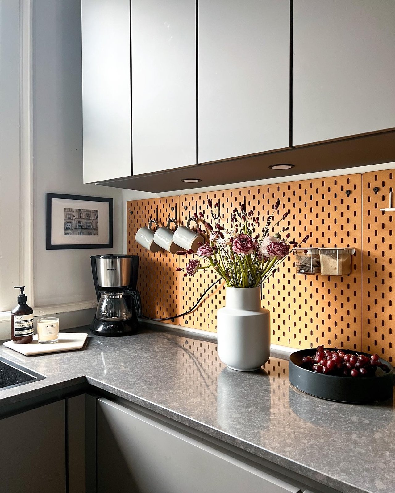 Warm wood pegboard, hooks, cups, and jars inspire ikea skadis craft room ideas
