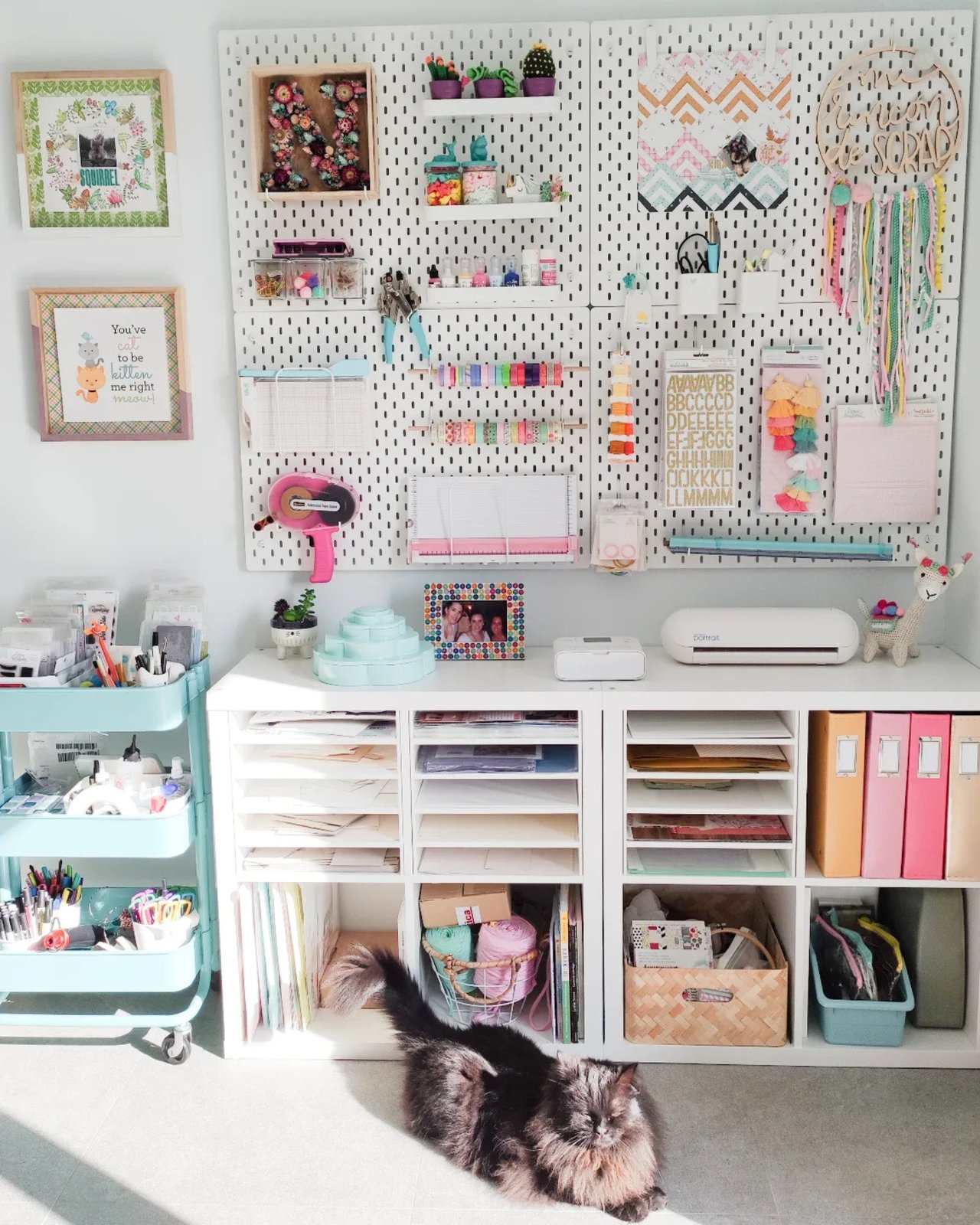 Colorful pegboard craft room with thread storage, paper supplies, shelves, and cheerful handmade details