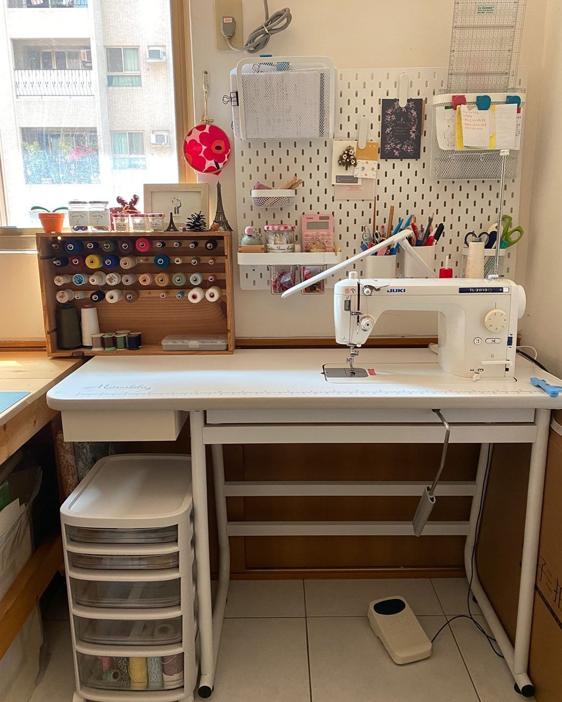 ikea skadis craft room ideas with pegboard storage, thread rack, and sewing machine